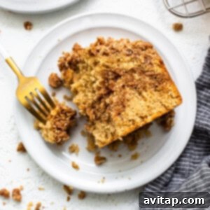 A beautiful slice of cinnamon streusel coffee cake and a latte.