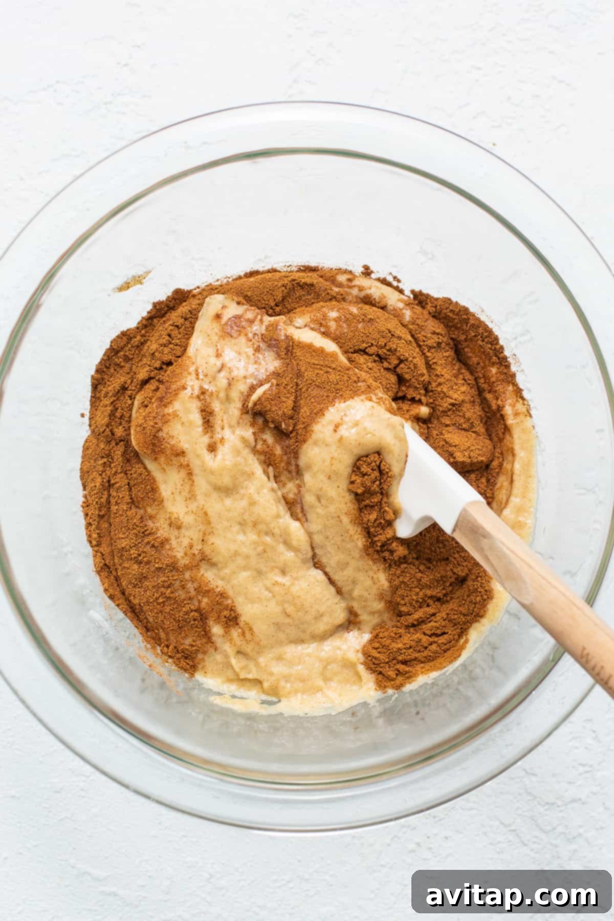 Adding cinnamon to a portion of the cake batter to create a swirl effect.