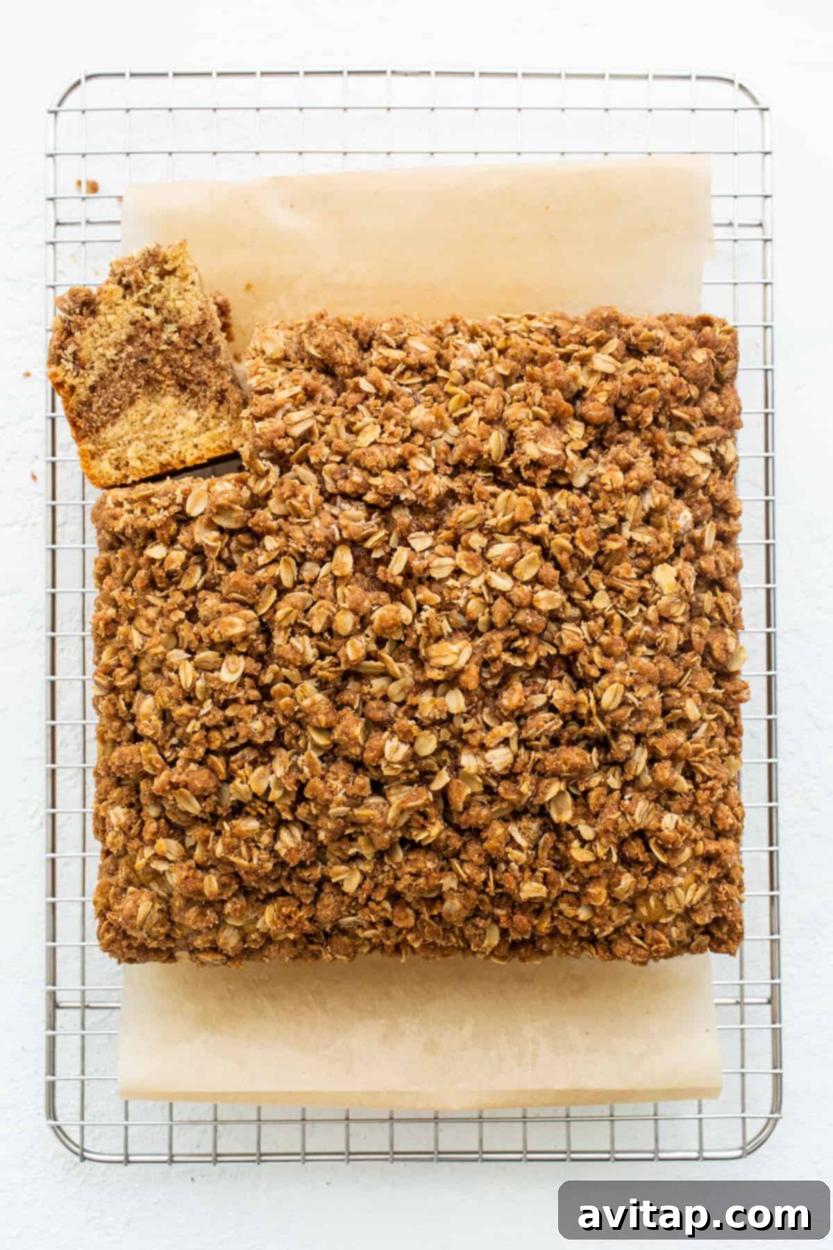 A sliced coffee cake cooling on a wire rack, revealing its layers.
