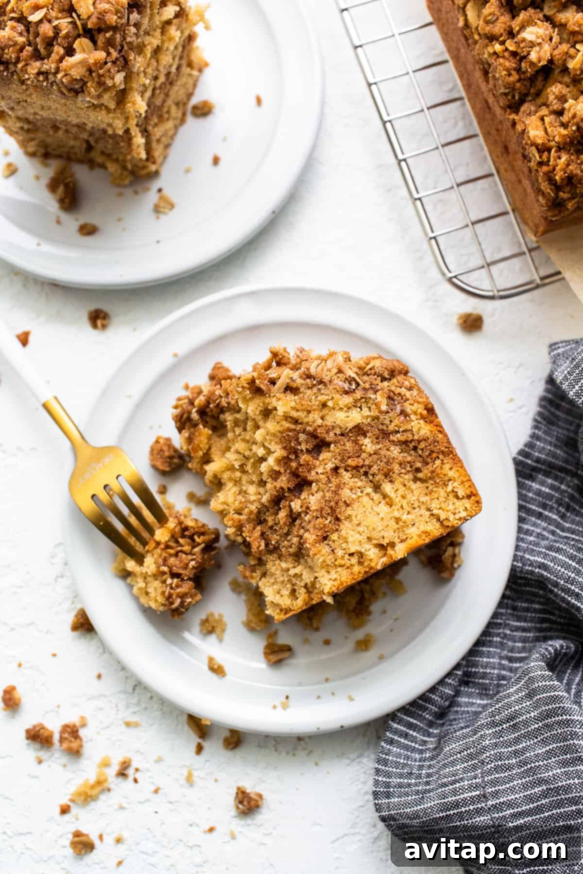 A perfect slice of cinnamon streusel coffee cake on a plate, ready to be served.