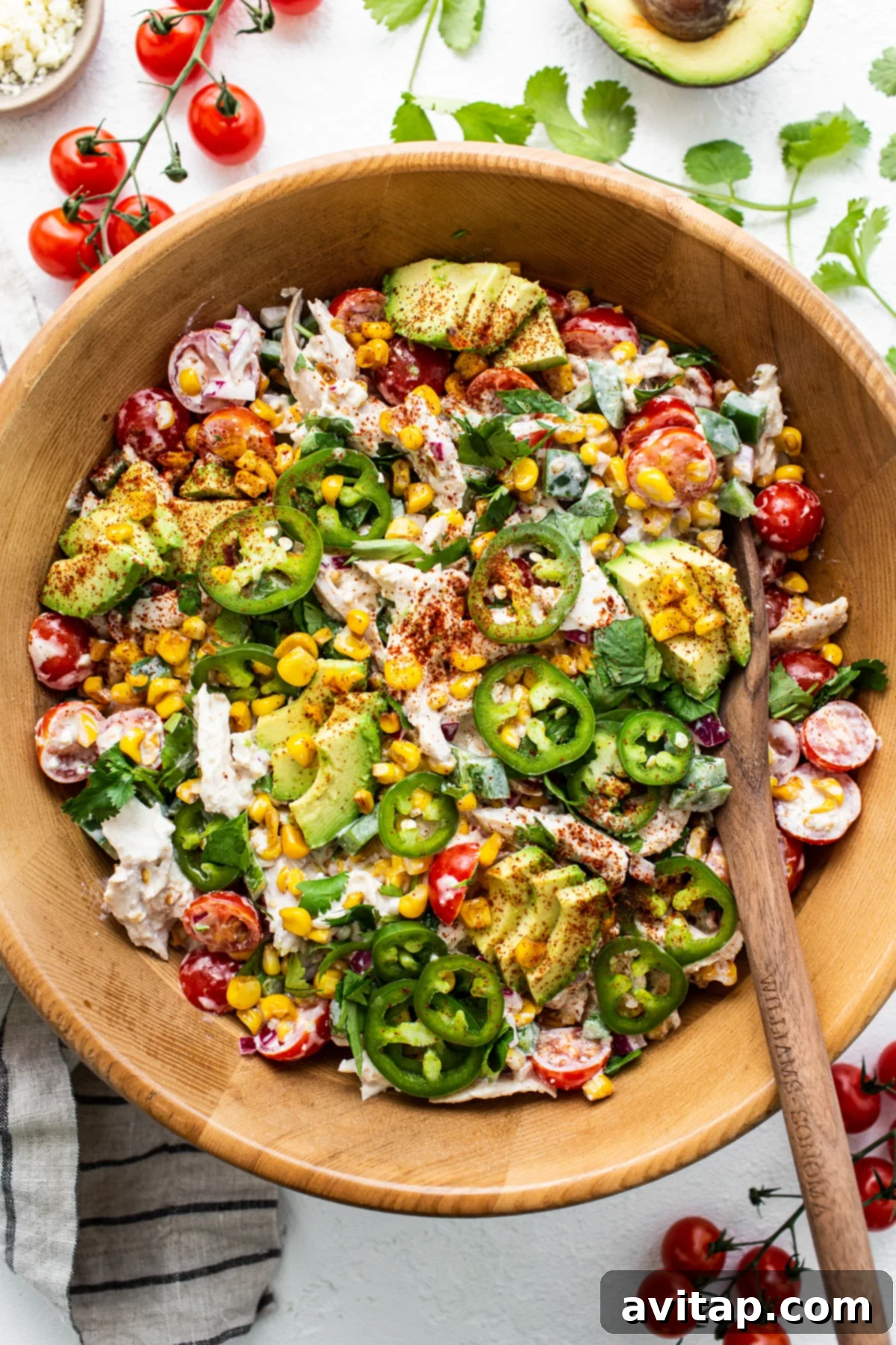 Street Corn Chicken Salad - A Festive and Flavorful Meal Prep Idea Vibrant street corn chicken salad in a large bowl, garnished with fresh cilantro and pickled jalapeños.