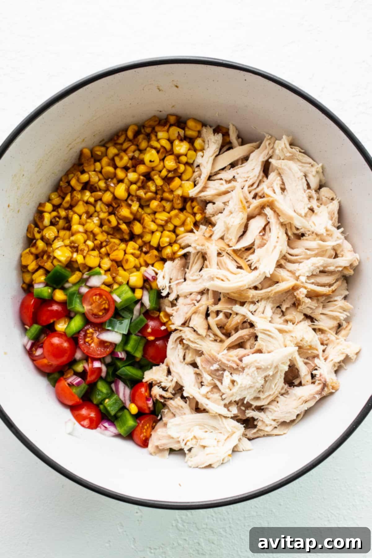 Fresh Ingredients Ready for Street Corn Chicken Salad All the fresh ingredients for street corn chicken salad in a large mixing bowl before being combined.