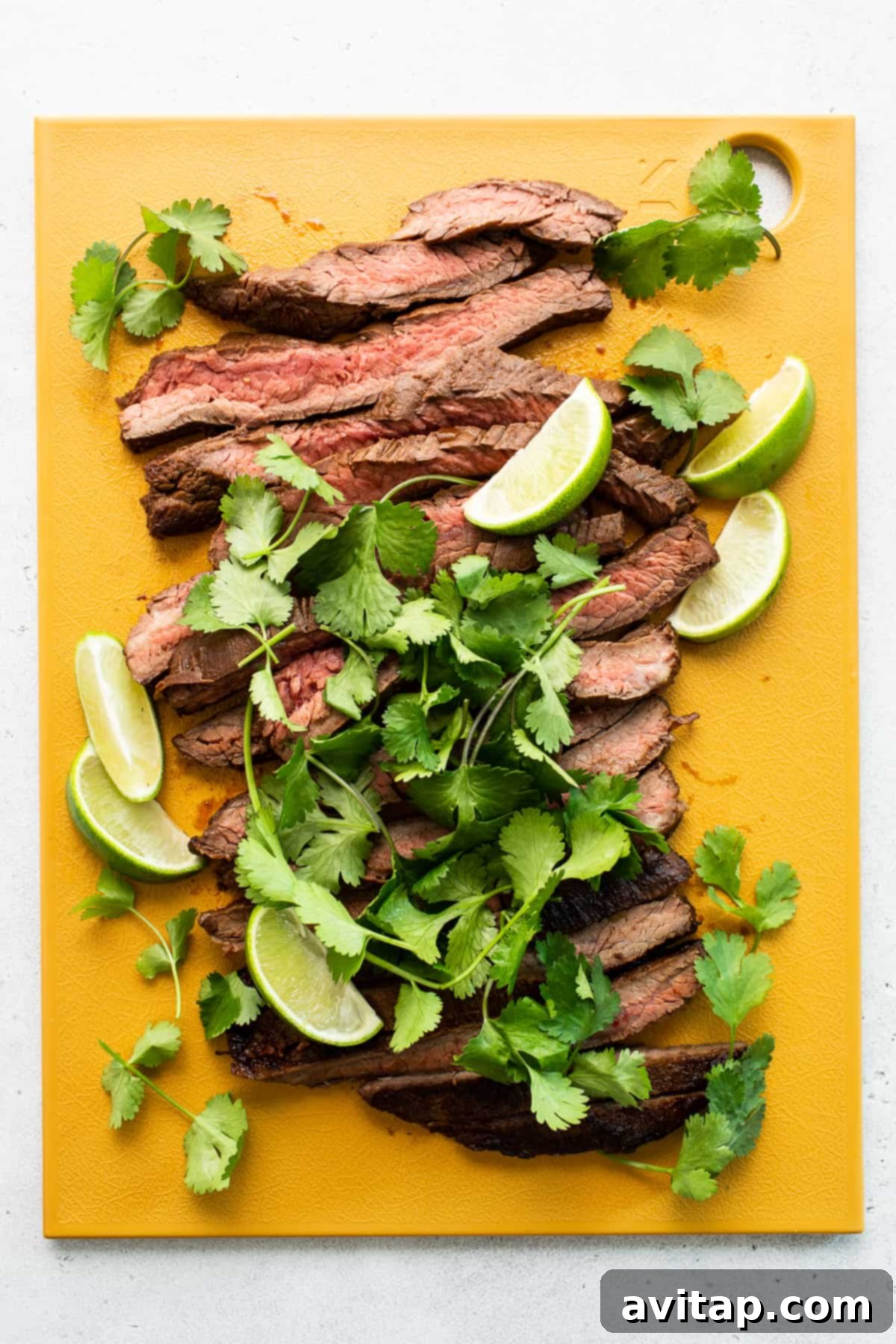 Ultimate Steak Fajita Marinade for Tender, Flavorful Steak Perfectly sliced marinated steak on a wooden cutting board, ready to serve.