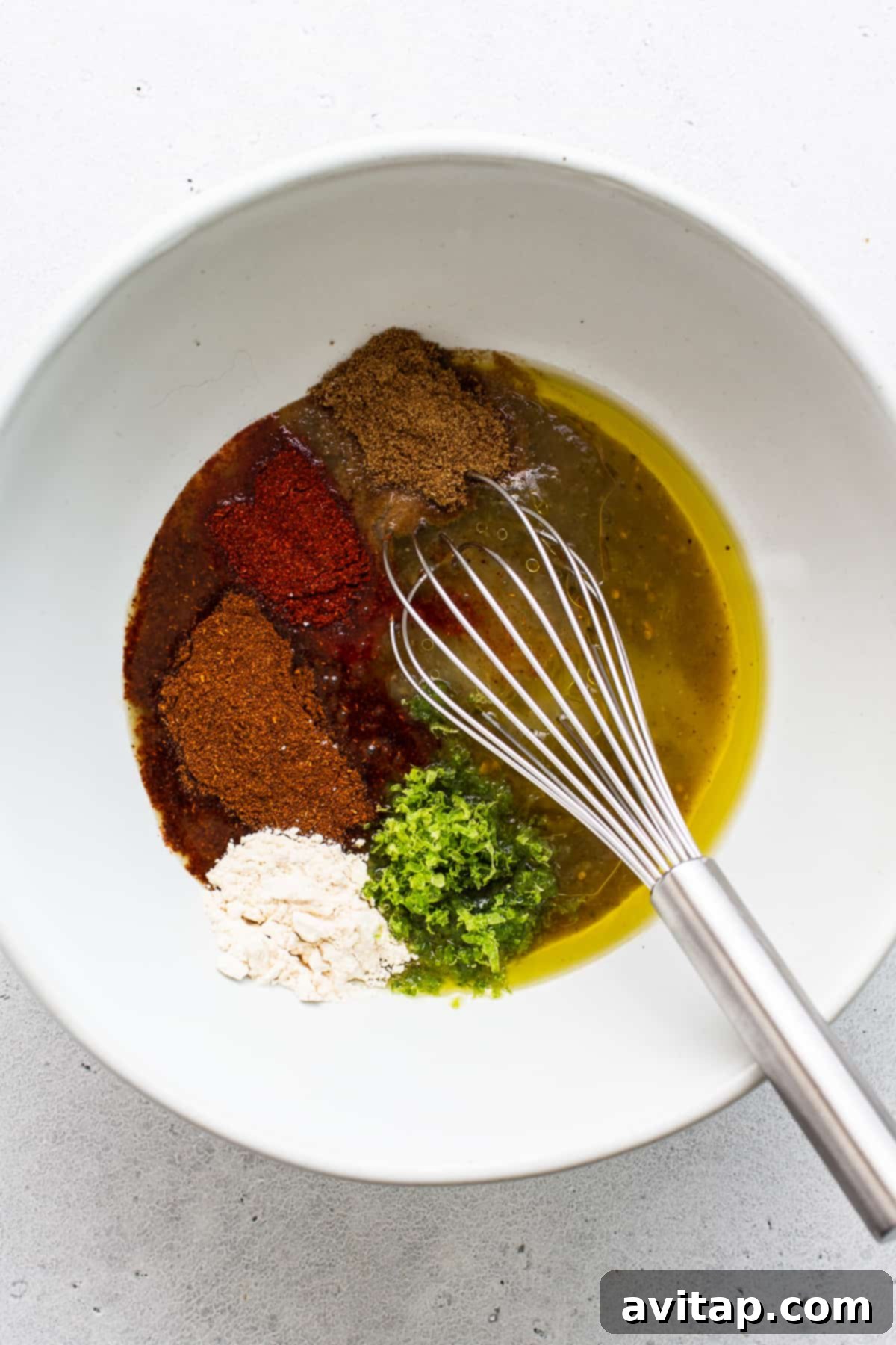 Freshly Mixed Steak Fajita Marinade The vibrant steak fajita marinade, freshly whisked and ready in a glass bowl.