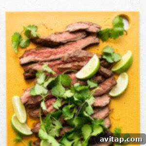 Ultimate Steak Fajita Marinade 4 Sliced steak on a cutting board, marinated and ready.