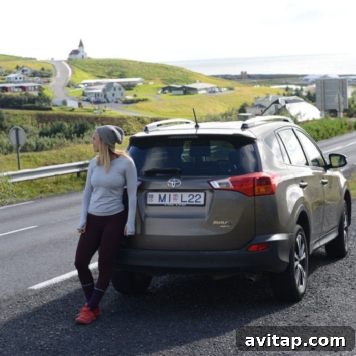 Hertz rental car, a white Rav4, parked in a scenic Icelandic landscape.