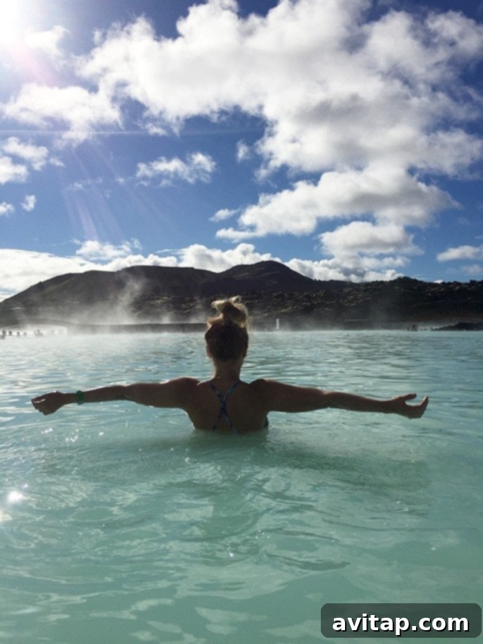 Couple relaxing in the Blue Lagoon, Iceland, with steam rising from the geothermal waters.