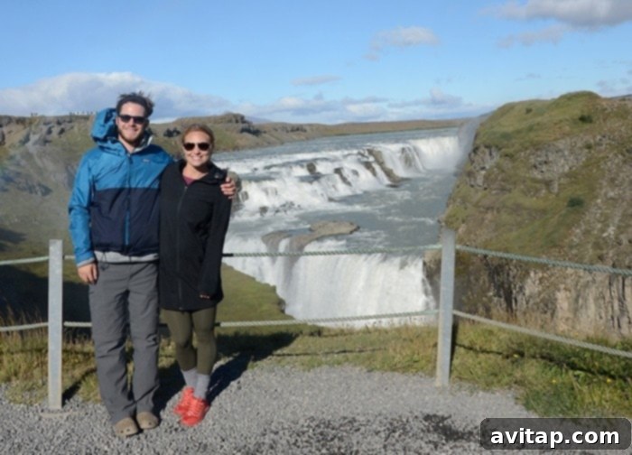 Gullfoss Waterfall in Iceland, with a double rainbow arching over the powerful cascades.