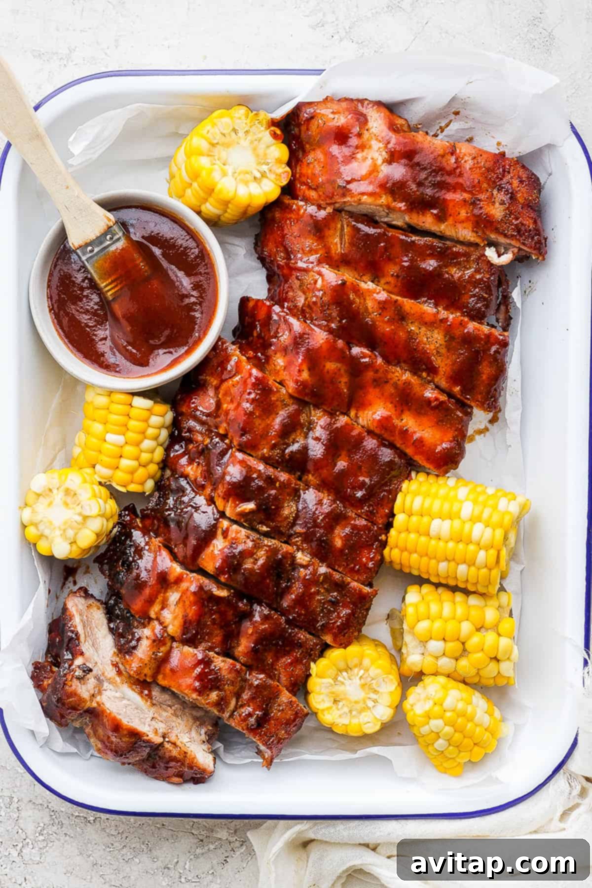 Grilled ribs beautifully arranged on a serving tray, garnished and ready to be enjoyed.