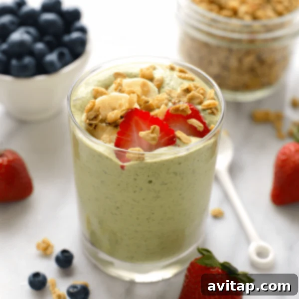 A green smoothie with berries and granola.