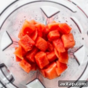 Watermelon blending in a high-speed blender, pureeing into juice for the freeze pops.