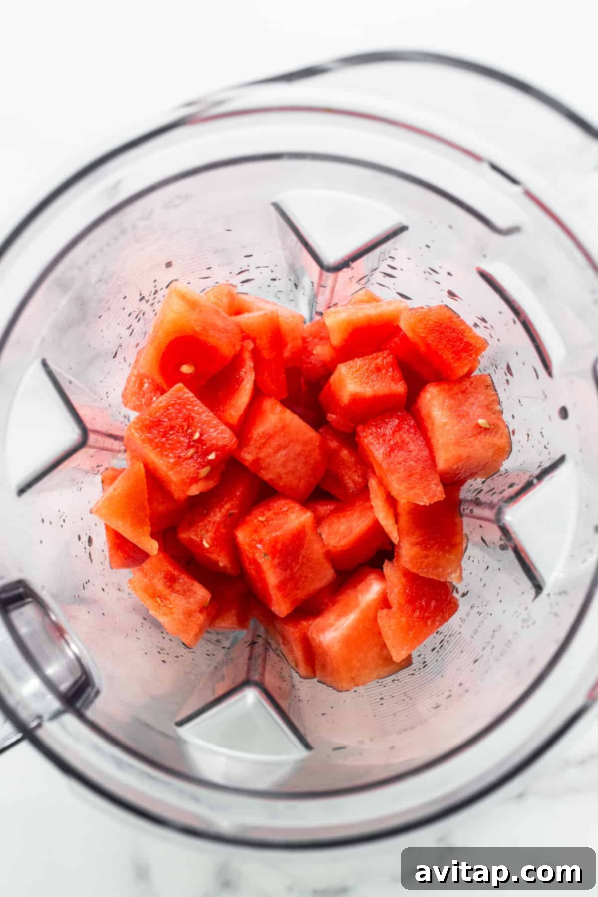 Fresh, vibrant watermelon chunks ready to be blended for delicious homemade wine freeze pops.