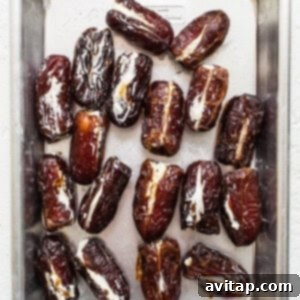 Dates being stuffed with goat cheese.