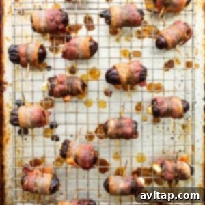 Bacon wrapped dates on a baking sheet, secured with toothpicks.