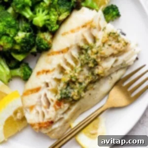 Grilled fish on a plate with broccoli, perfectly cooked and ready to serve.