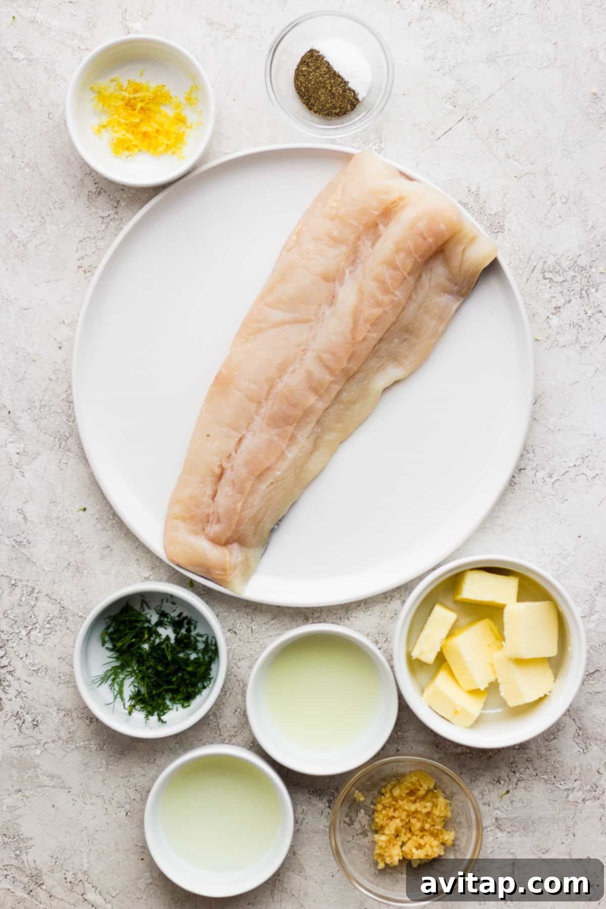 Grilled fish ingredients on a plate and in bowls, ready for preparation.