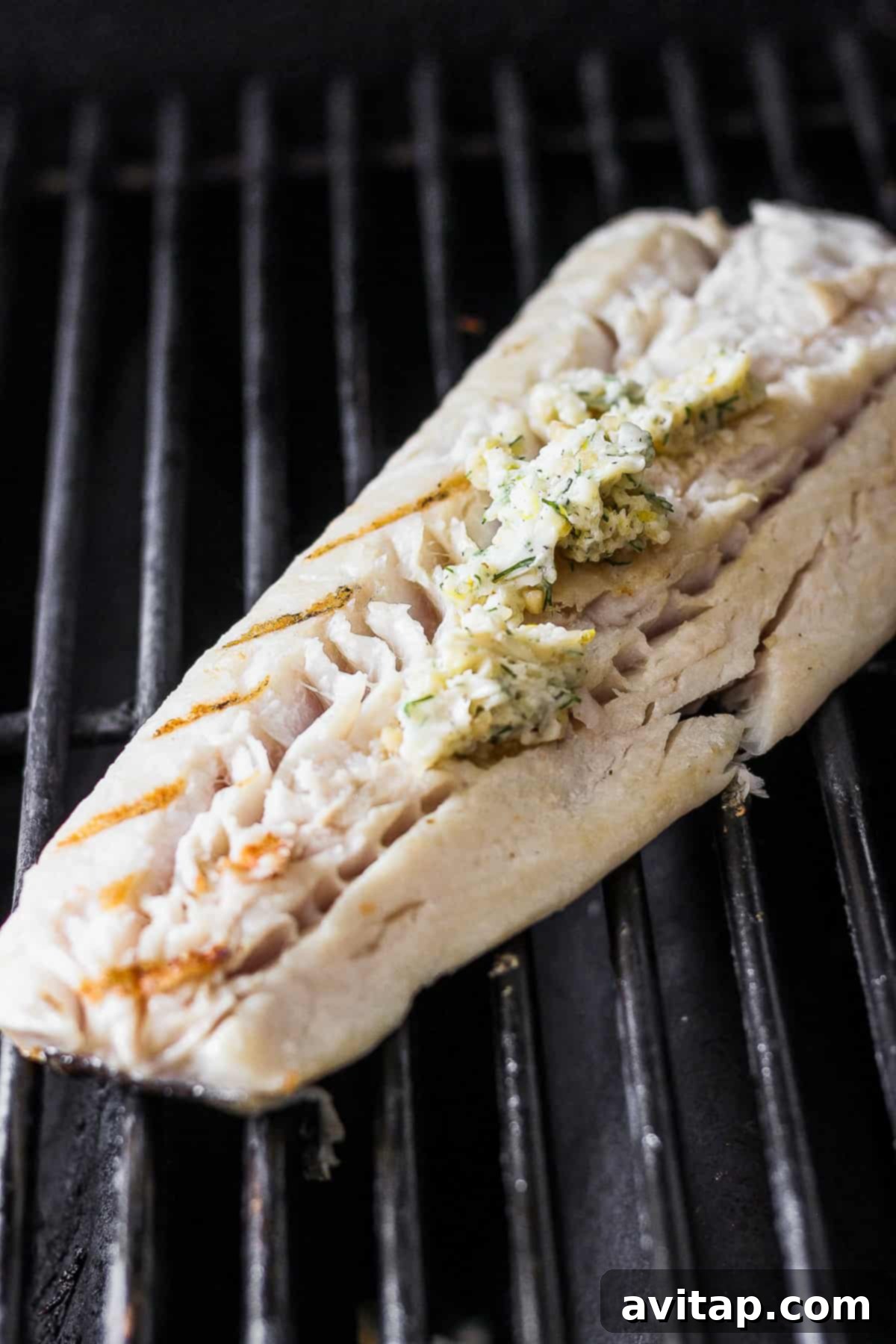 Dill butter marinade being mixed together in a bowl, showing its creamy texture.