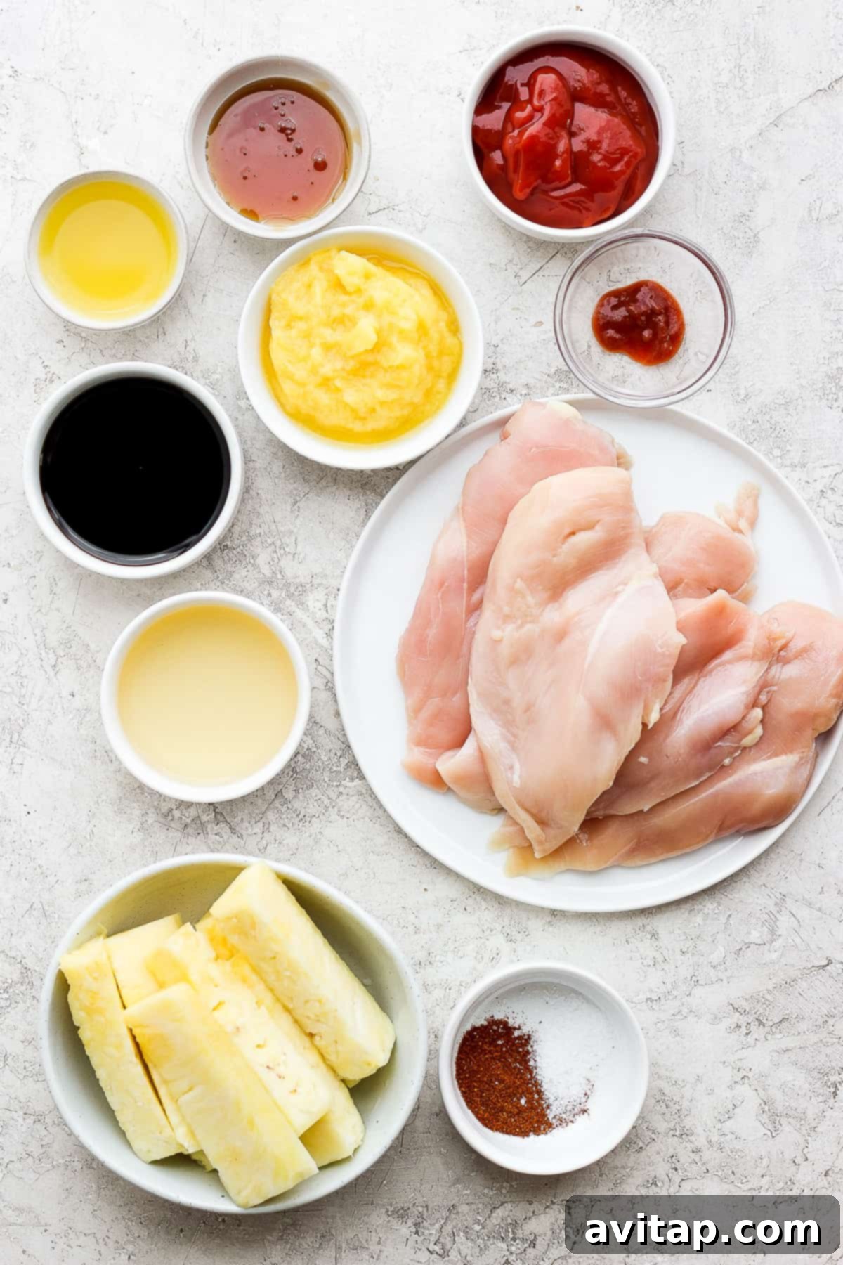 A beautifully arranged plate featuring grilled chicken, golden-brown pineapple slices, and vibrant garnishes.