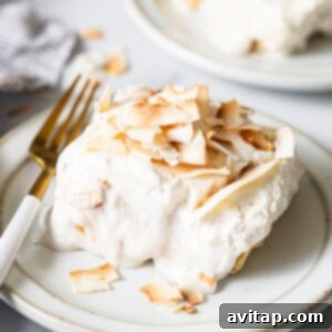 A white plate topped with a piece of cake.