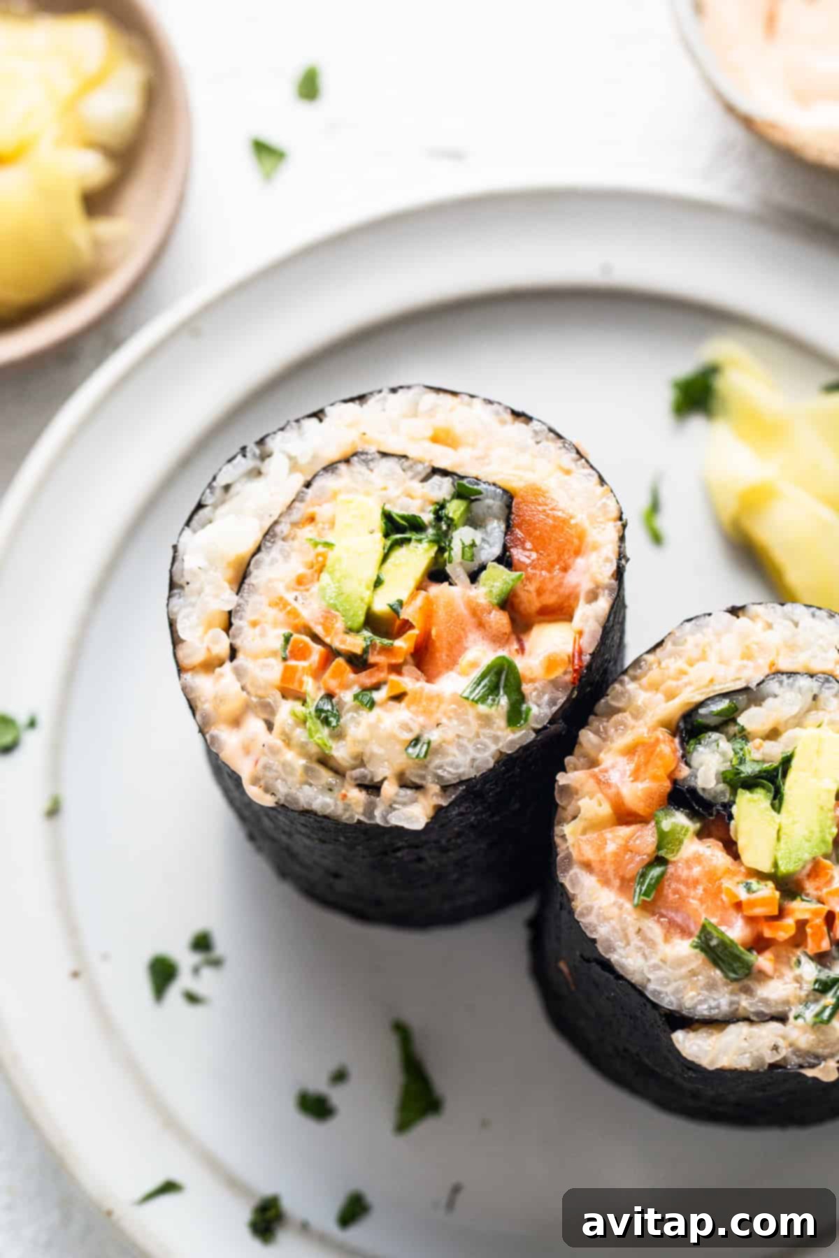 A vibrant salmon sushi burrito served on a white plate next to a fresh pineapple, highlighting a delightful meal experience.