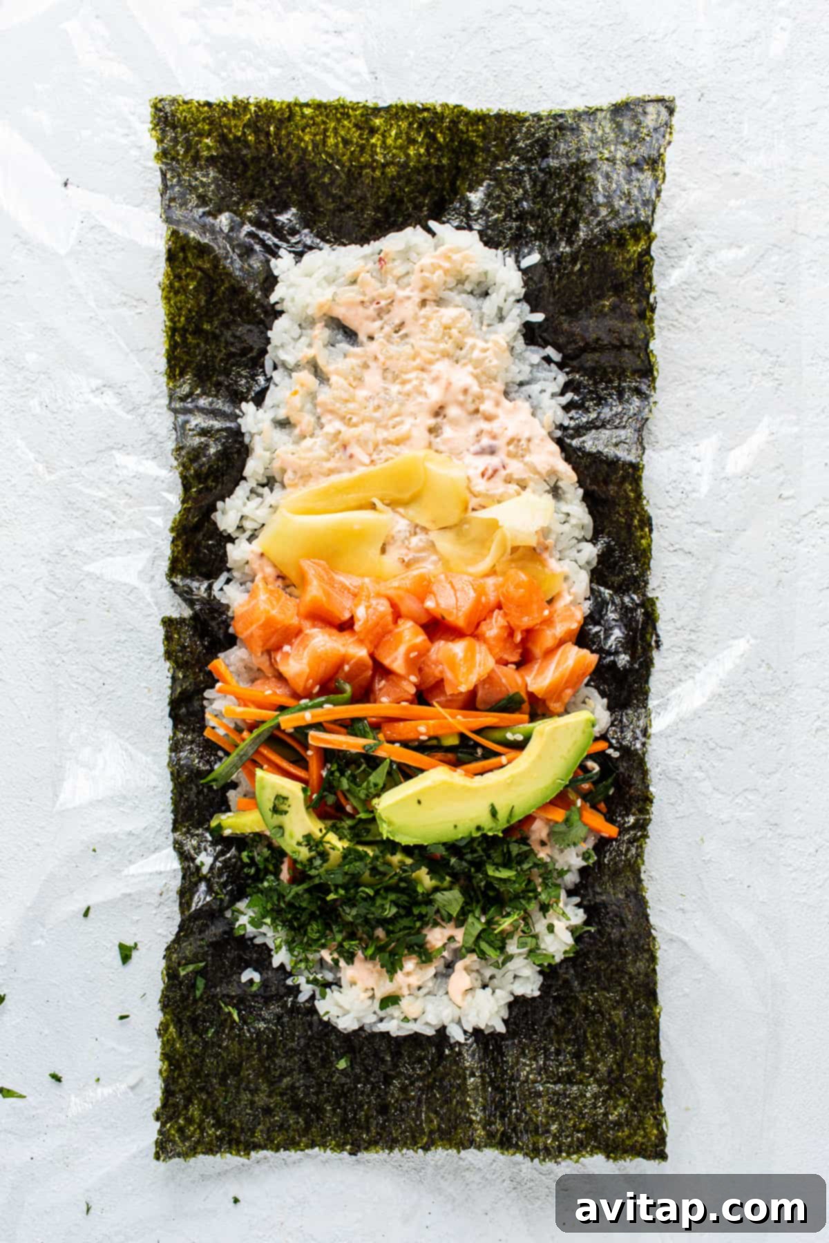 A meticulously arranged sushi platter featuring fresh salmon, creamy avocado, crisp carrots, and other vibrant garnishes, showcasing the artistry of Japanese cuisine.