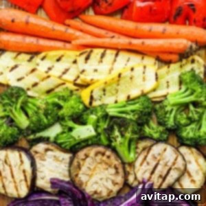 A variety of colorful vegetables laid out on a cutting board, ready for grilling.