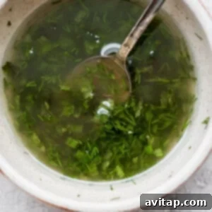 A bowl of fresh herb dressing, ready to be used on the grilled vegetables.