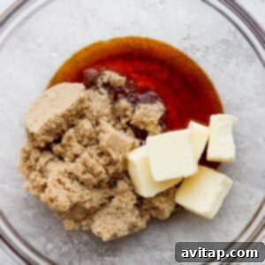 A bowl filled with butter and sugar, being creamed with an electric mixer.