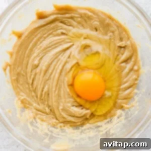 a bowl of peanut butter with an egg in it.