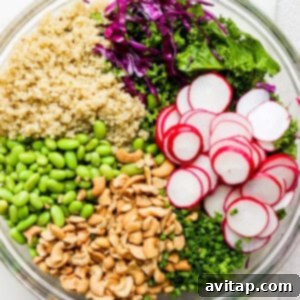 A bowl filled with greens, radishes and quinoa.