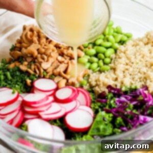 A person pouring dressing into a bowl of greens and radishes.
