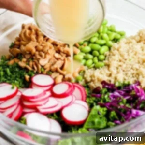 A person pouring dressing into a bowl of greens and radishes.
