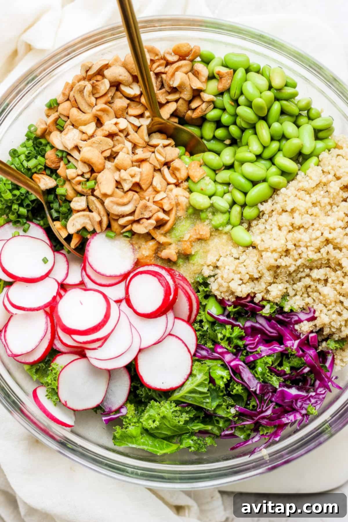 A large bowl filled with greens, radishes, quinoa, and other healthy ingredients, signifying a complete and satisfying meal.