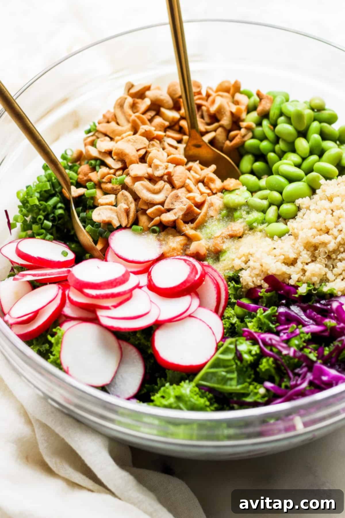 A close-up shot of the finished Honey Ginger Quinoa Kale Salad, showcasing its colorful ingredients and appetizing texture.
