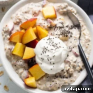 A bowl of oatmeal with peaches and whipped cream.