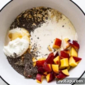 Dreamy Peach Overnight Oats 8 A bowl with yogurt, peaches and chia seeds mixed together.