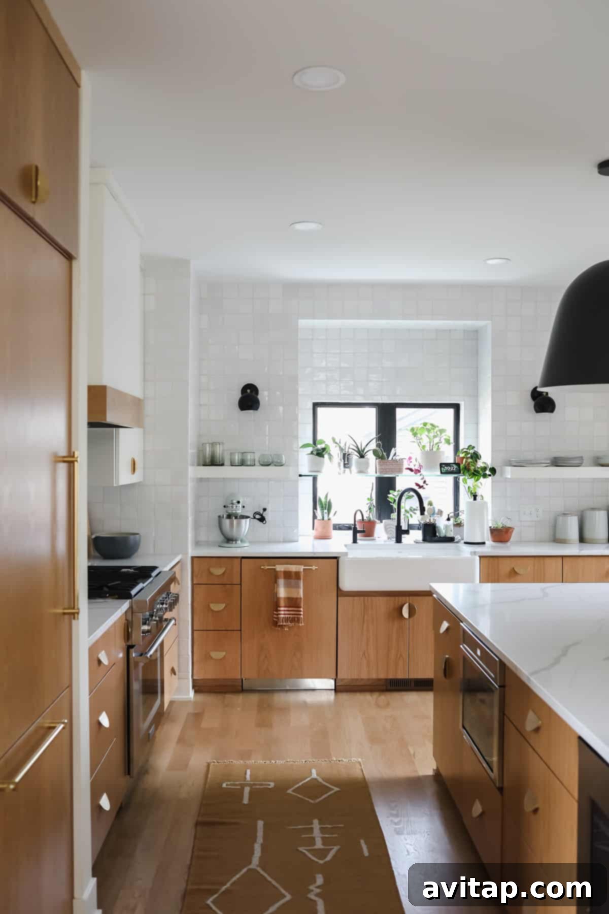 A beautifully designed kitchen featuring white subway tile, sleek countertops, and a striking black light fixture, showcasing the integrated appliance aesthetic.
