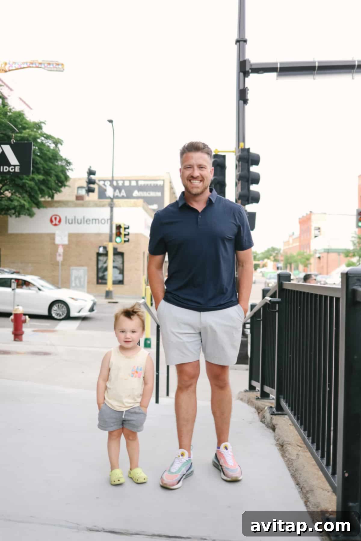 A man in Commission shorts enjoying time with a little girl on a sidewalk, highlighting casual family moments.