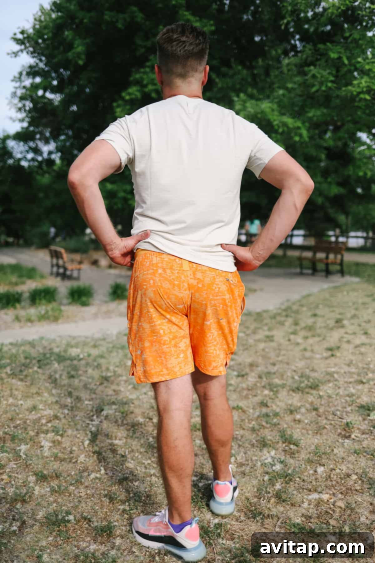 Rear view of a man in License to Train shorts, showcasing the fit and freedom of movement in an open field.