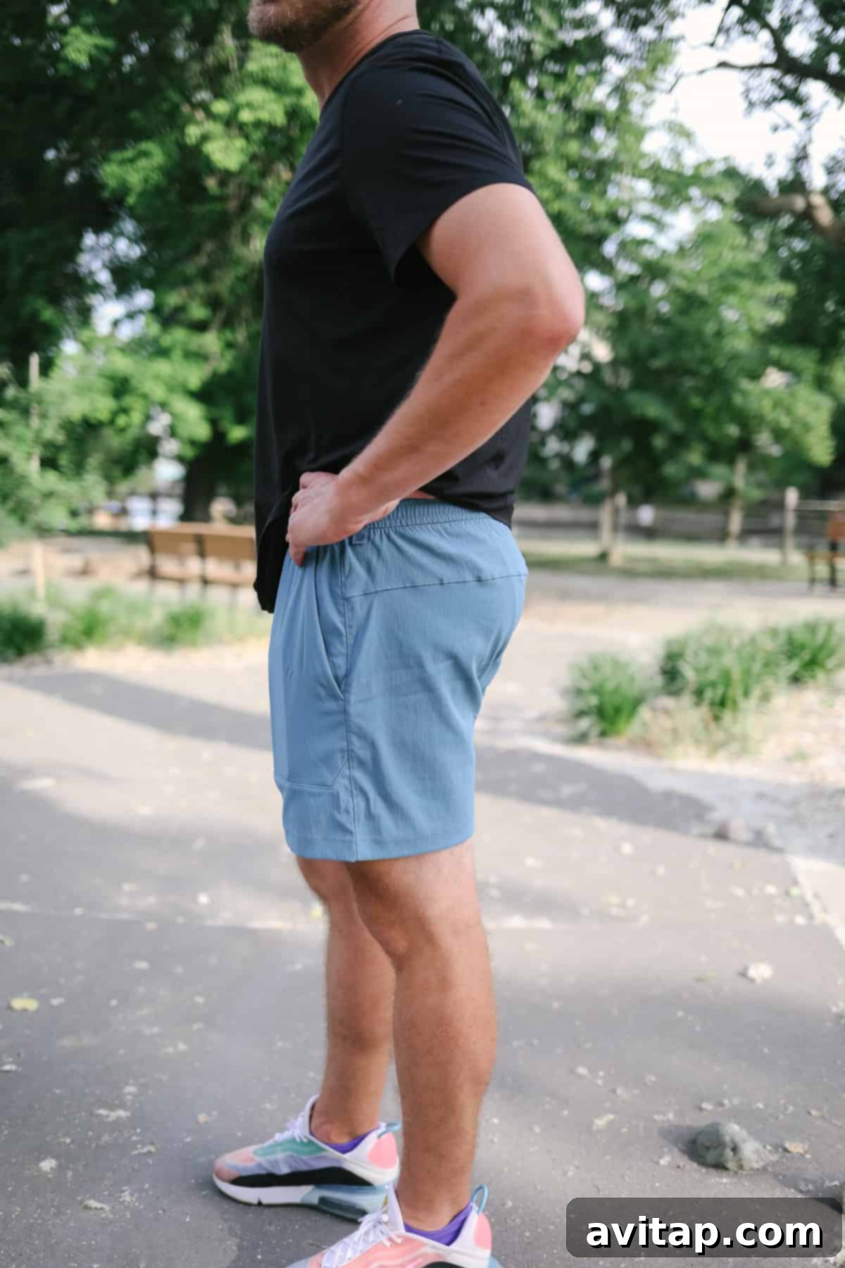 A man in Lululemon Bowline shorts casually standing in a park, highlighting the short's relaxed aesthetic.