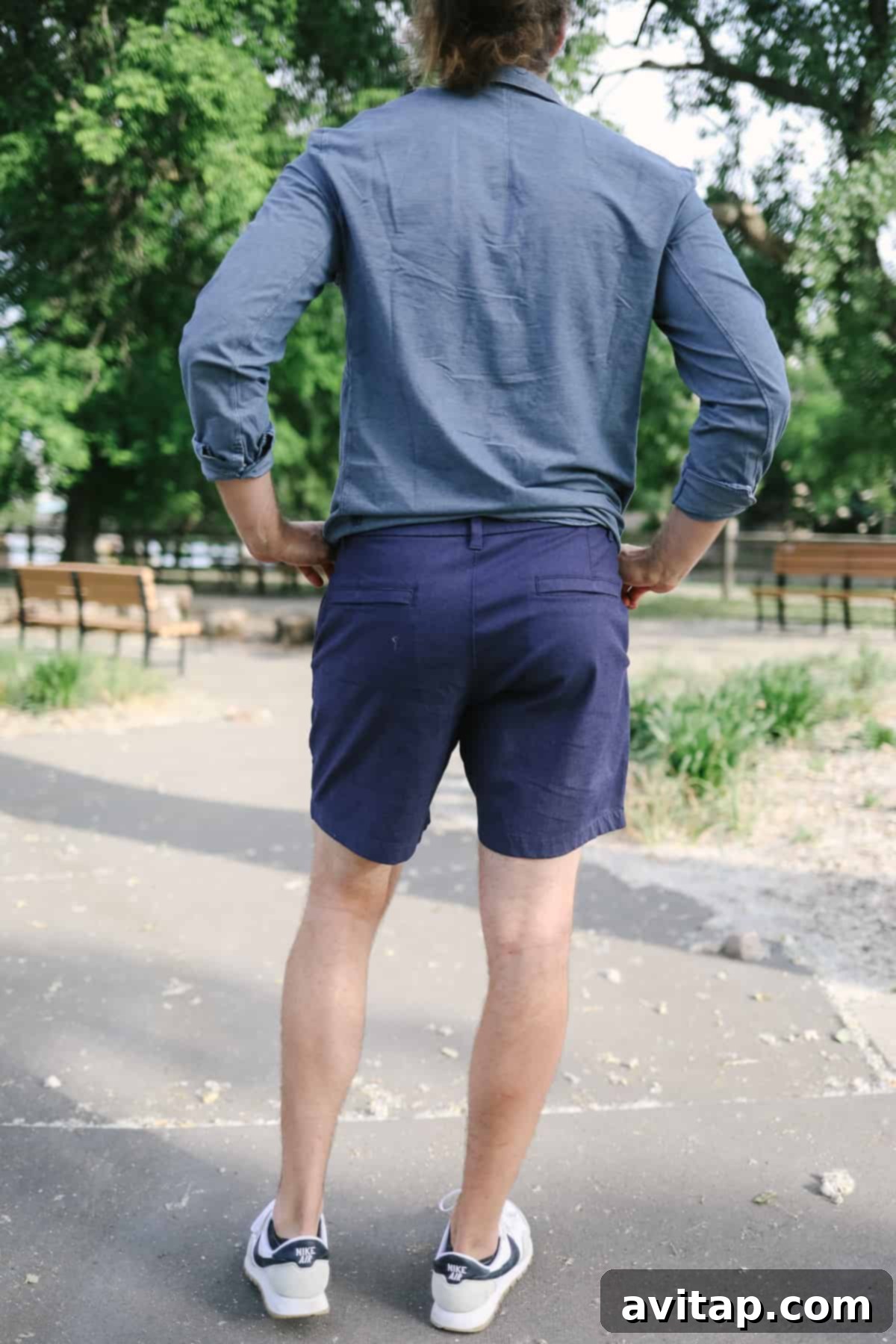 A man in a smart blue shirt and Lululemon Commission shorts, exuding casual sophistication.