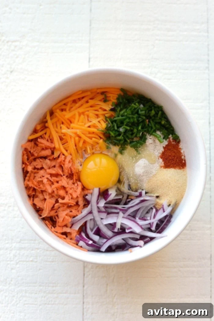 Fresh Ingredients for Flavorful Sweet Potato Hash Browns A bowl filled with all the ingredients for sweet potato hash browns, ready to be mixed.