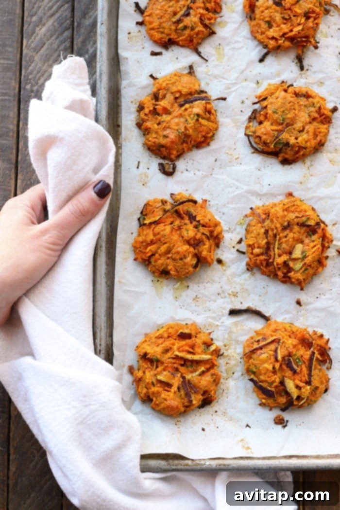 Golden-Brown Baked Sweet Potato Fritters on a Tray Crispy baked cheddar sweet potato hash browns arranged on a baking tray after cooking.