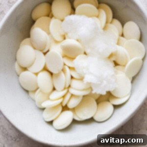 White chocolate chips and coconut oil in a bowl, ready to be melted.