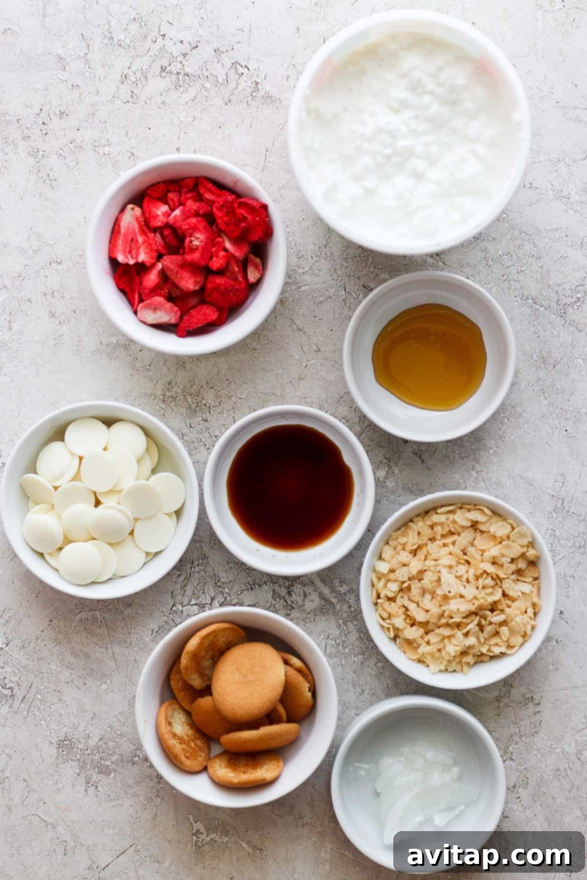 Bowls of ingredients including vanilla wafers, freeze-dried strawberries, and white chocolate chips.