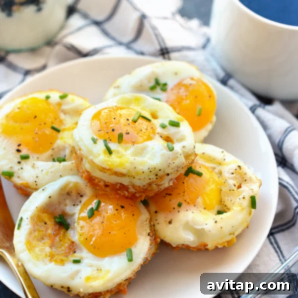 Sweet Potato Hash Egg Bites 4 Beautifully baked Sweet Potato Hash Egg Muffin Cups in a muffin tin, garnished.