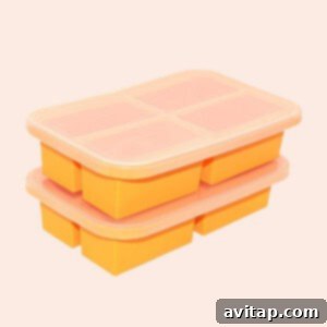 Postpartum Freezer Meal Prep Guide 6 A stack of orange silicone freezing trays, perfect for portioning and freezing soups and stews.