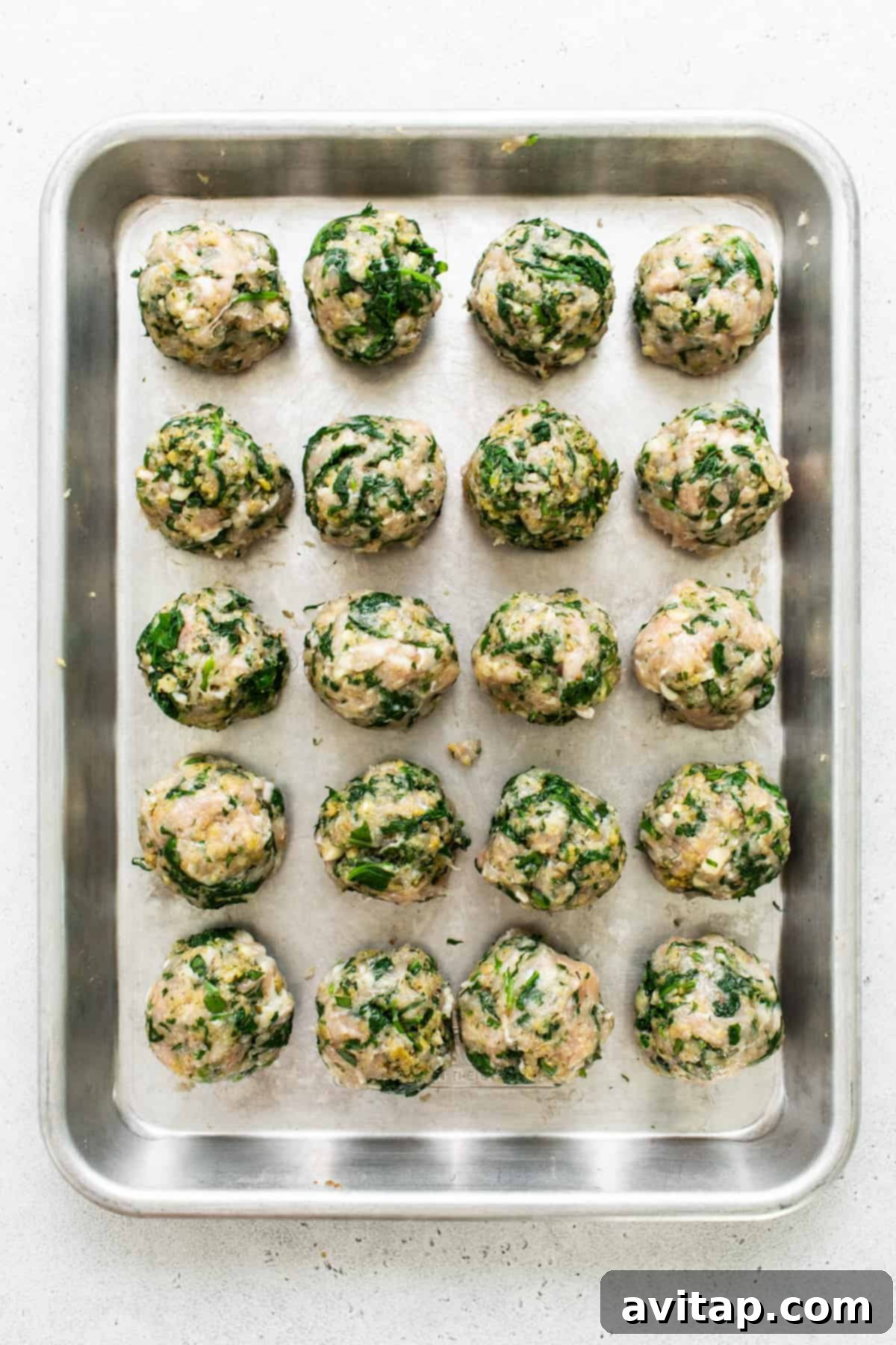 Spinach and mushroom meatballs on a baking sheet.