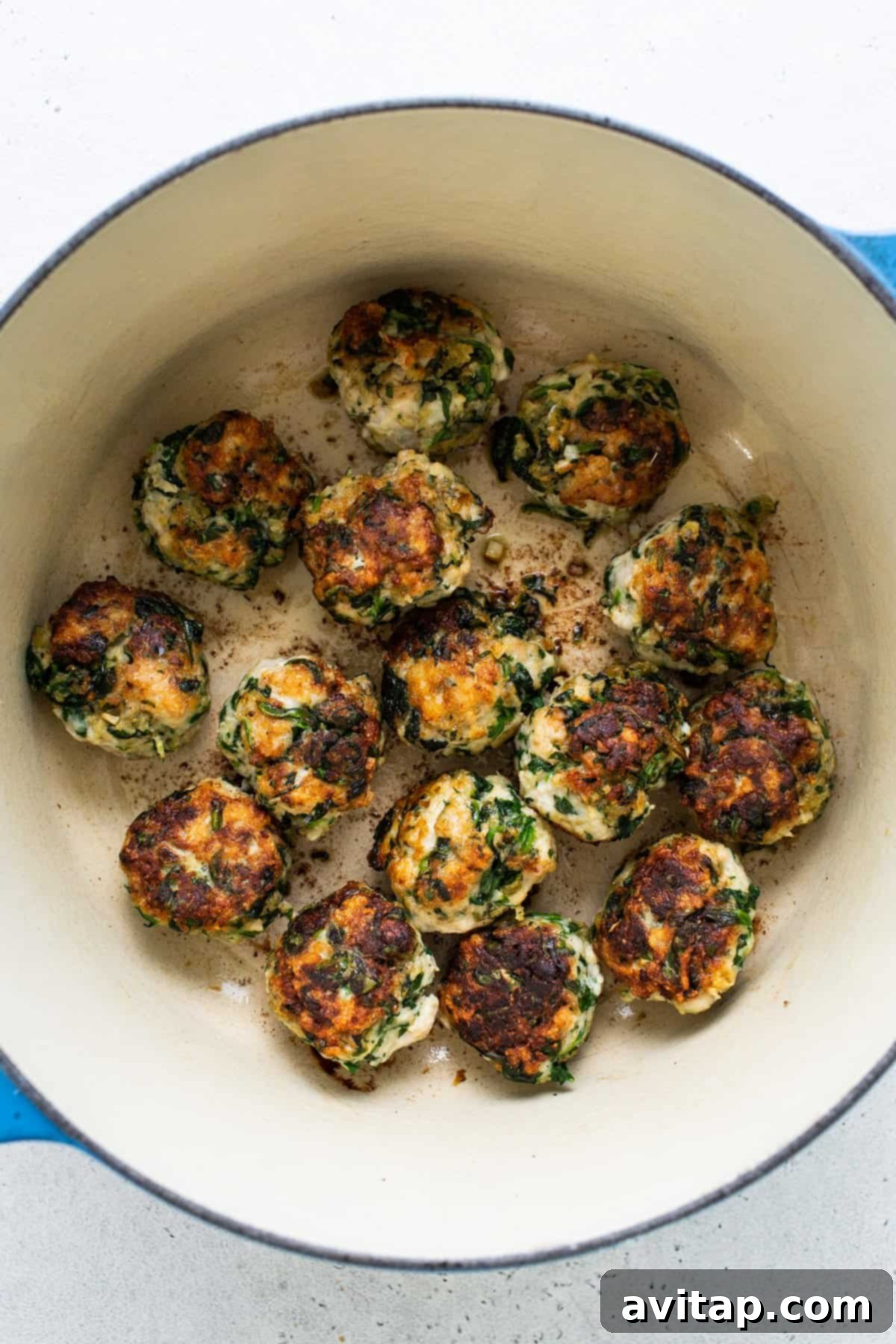 Chicken and spinach croquettes in a blue pot.