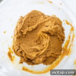 Warm Spiced Pumpkin Ginger Molasses Cookies 11 A bowl of pumpkin batter in a glass bowl.
